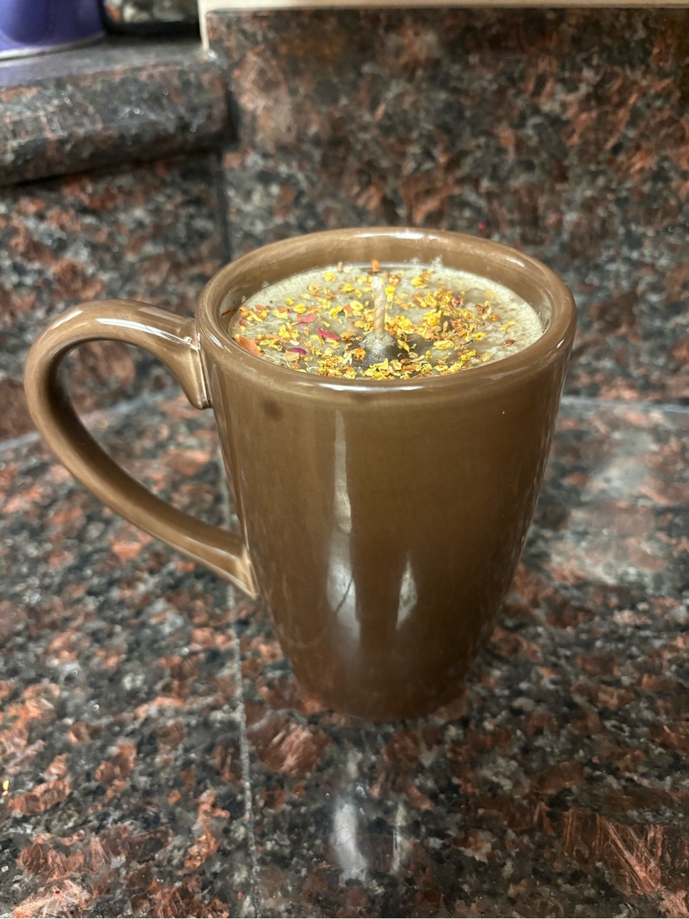 Handmade candle vanilla scented wax poured into a Brown mug with dried flowers